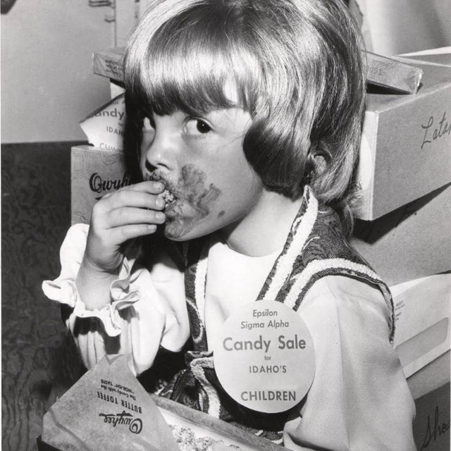 Girl eating with chocolate on her face