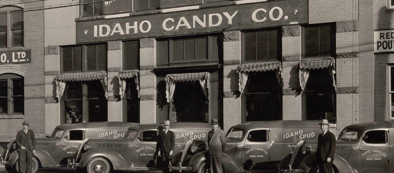 Idaho Spud delivery trucks in a row outside factory