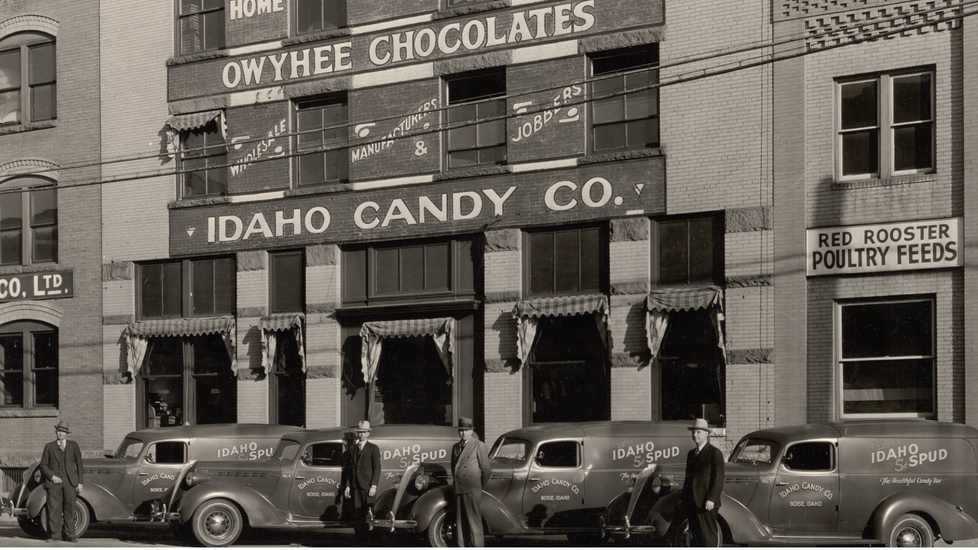 1900s Factory with Trucks Out Front